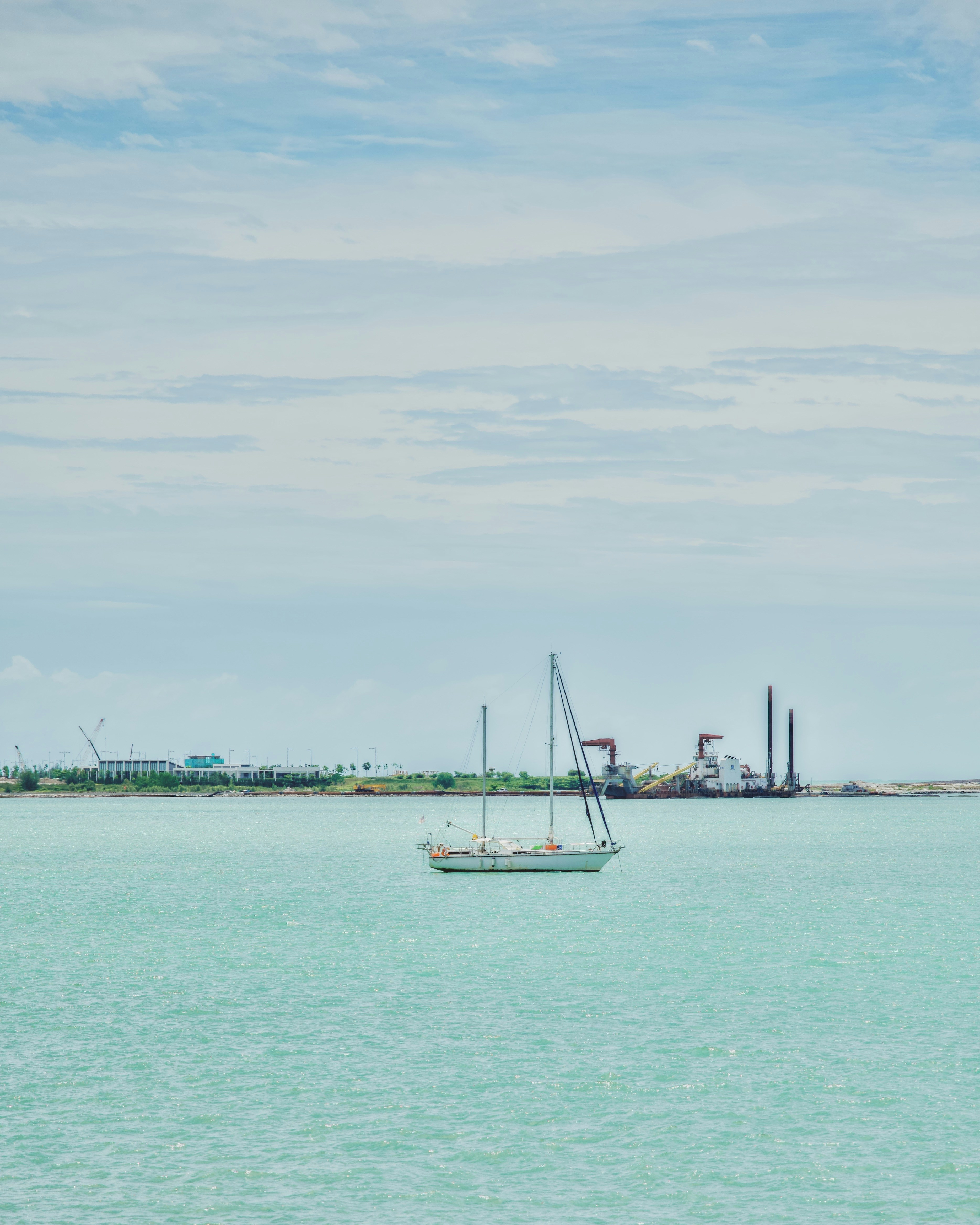 a sailboat floating in the middle of a large body of water
