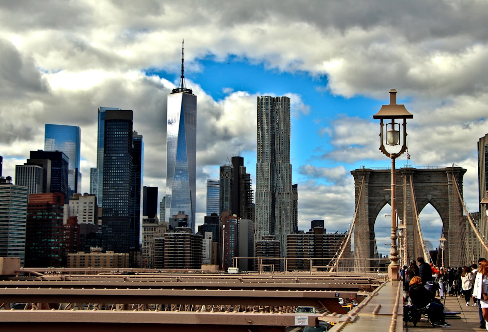 a group of people walking across a bridge