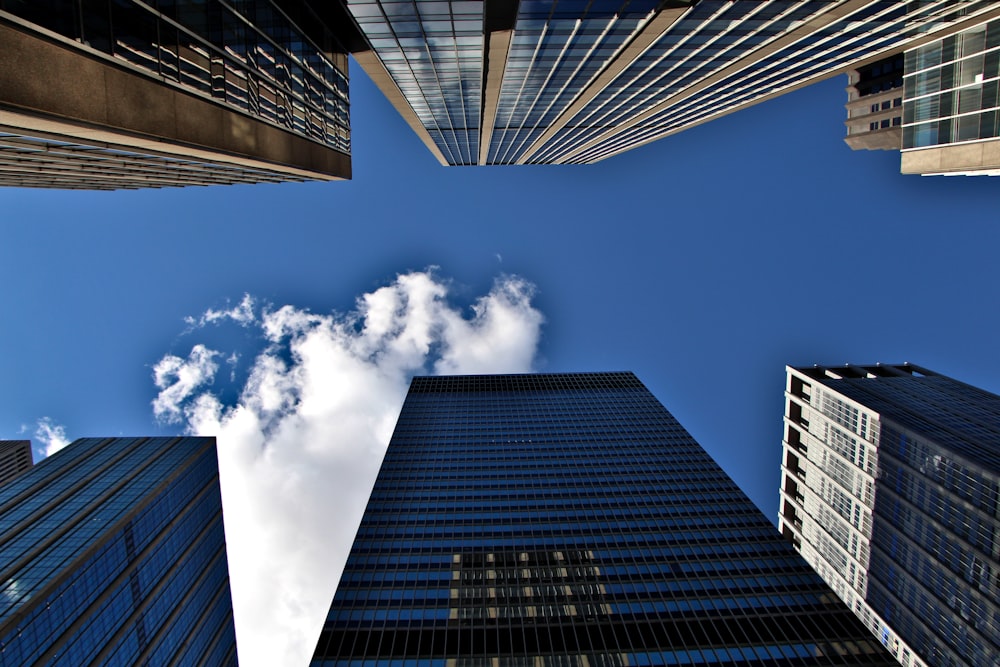 a group of tall buildings with a blue sky in the background