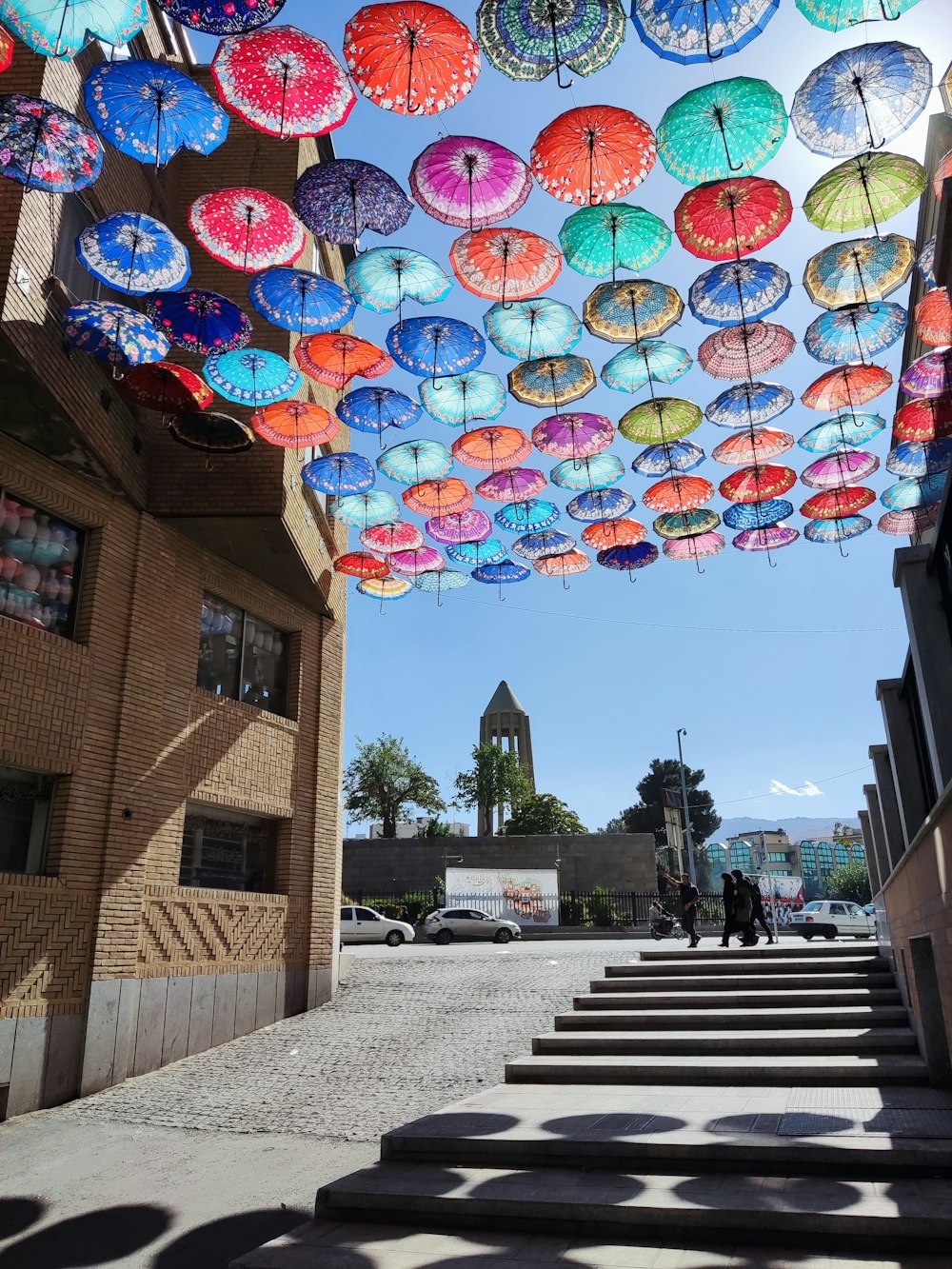 a bunch of colorful umbrellas hanging from the ceiling