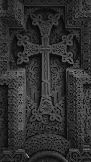 Close-up of intricate crosses carved into stone at a historic Ethiopian church.