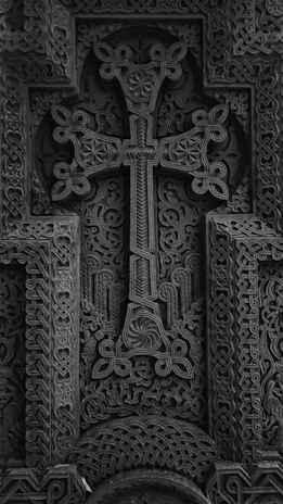 Close-up of intricate crosses carved into stone at a historic Ethiopian church.