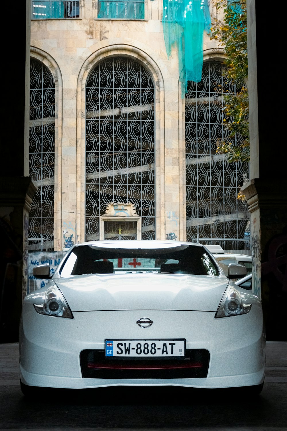 a white car parked in front of a building