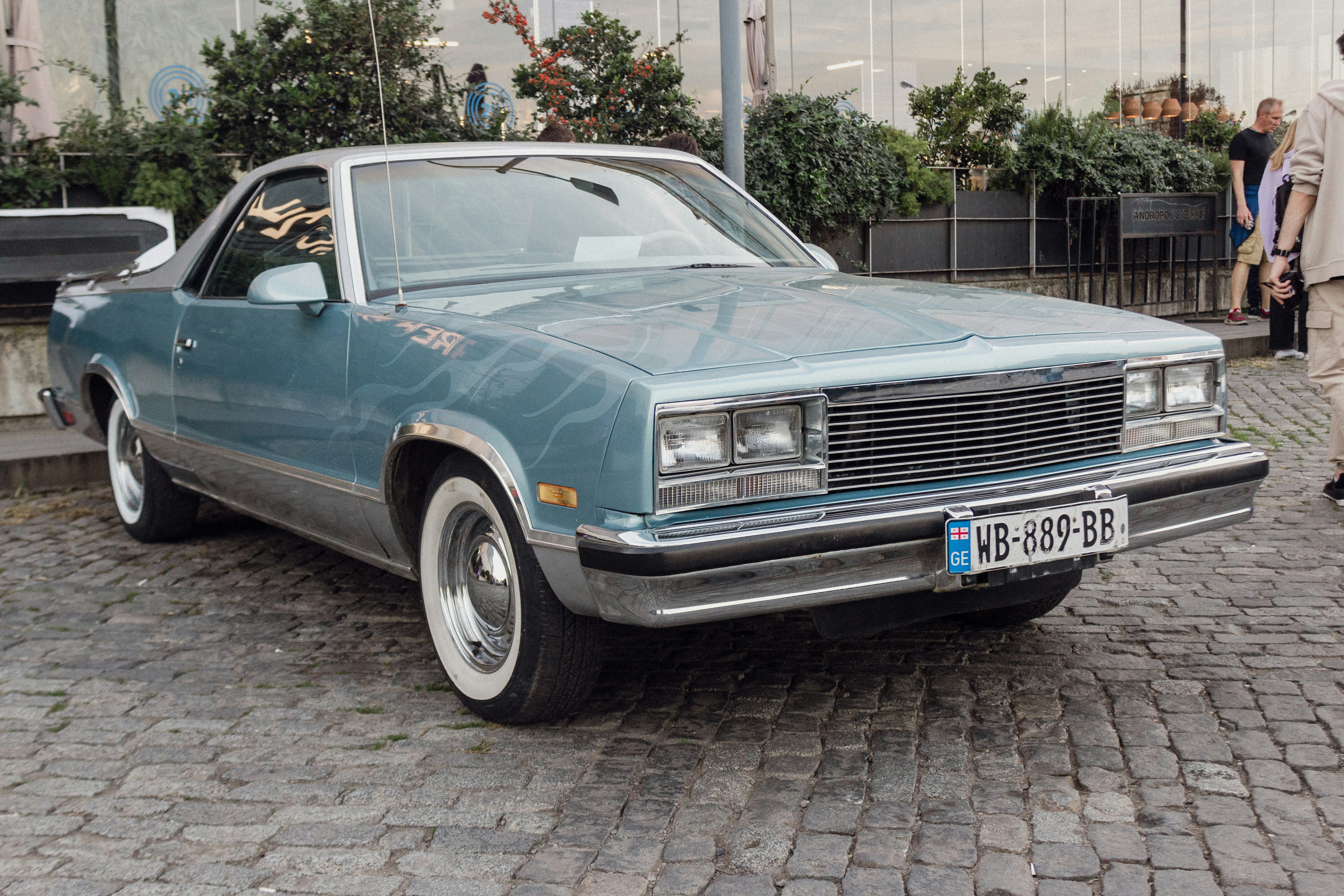 A blue car parked on a cobblestone street photo – Free Tbilisi Image on ...