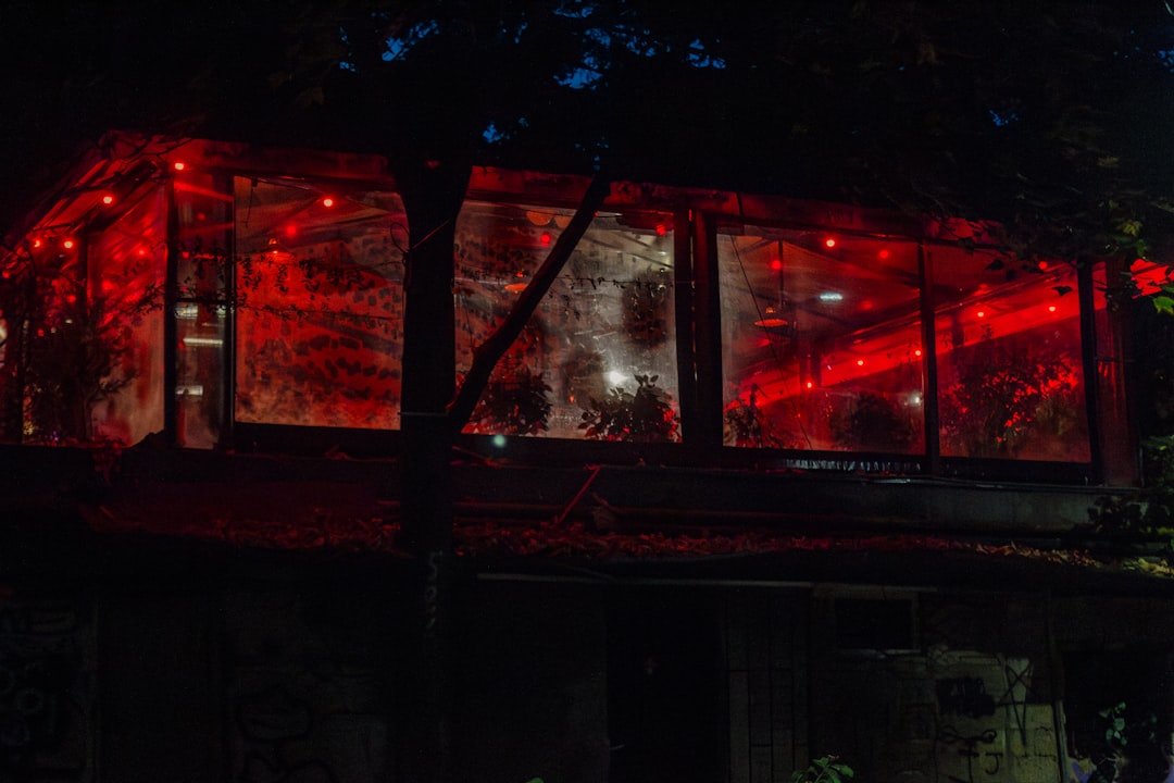 a building with red lights in the windows,