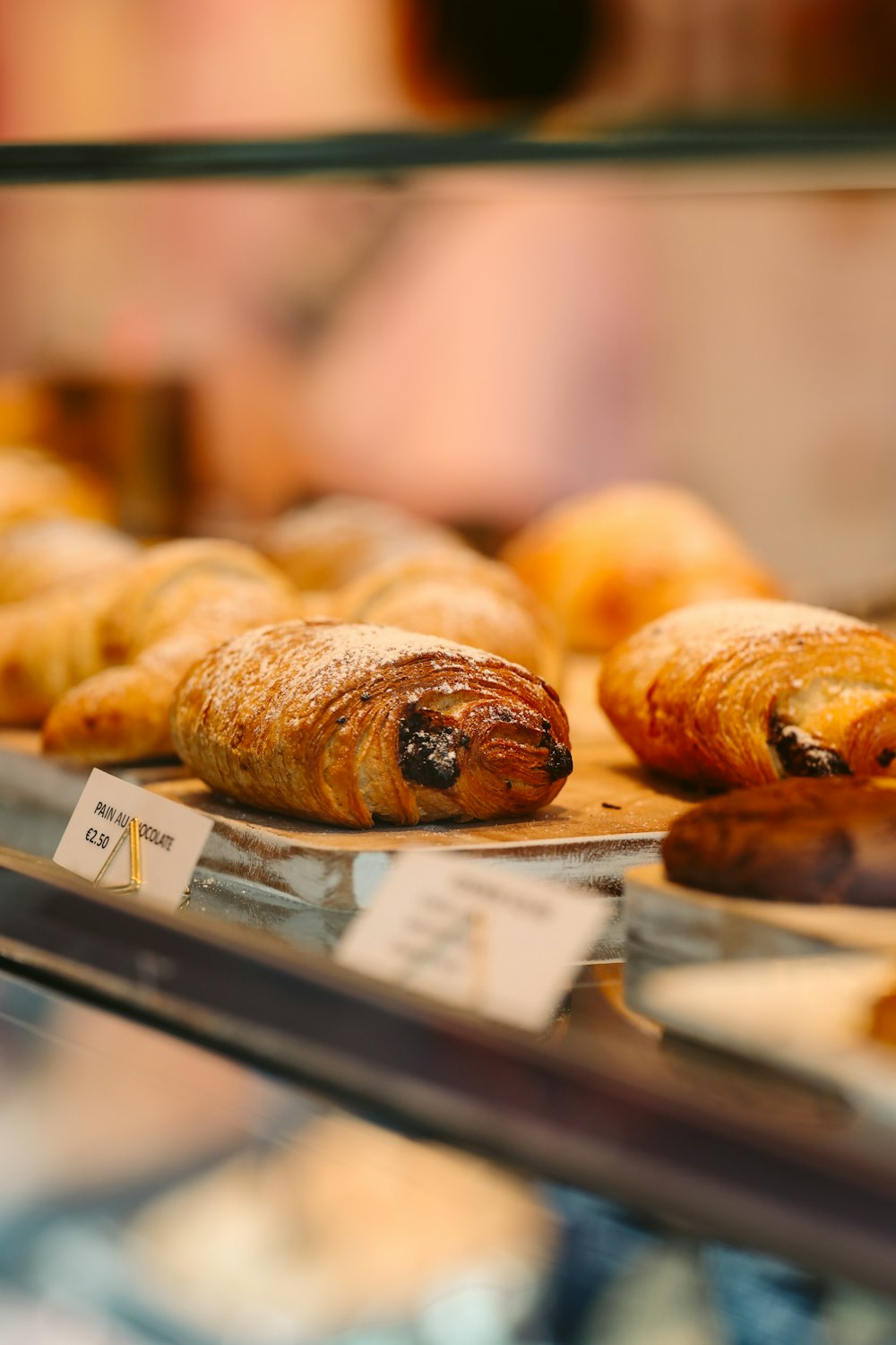 a close up of pastries in a display case