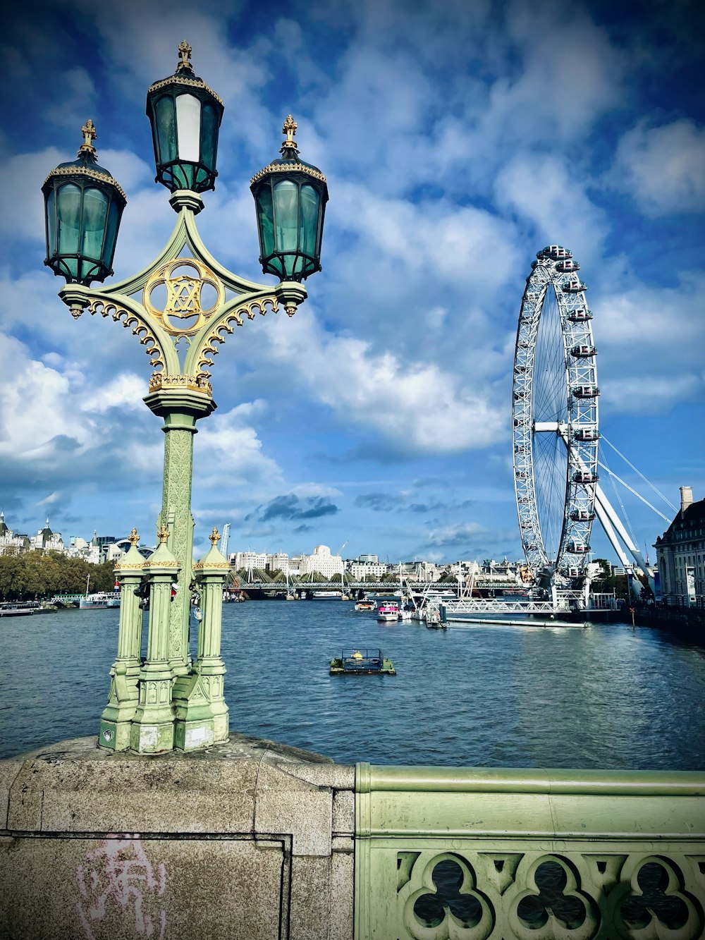 a lamp post with a ferris wheel in the background