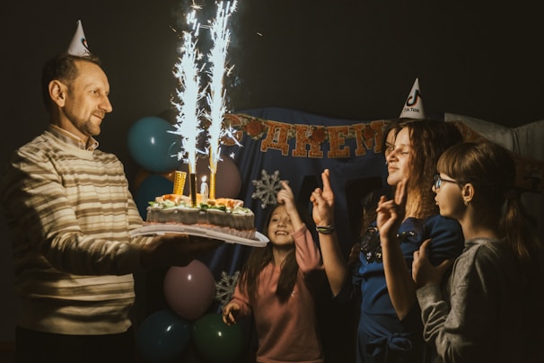 A joyful celebration with balloons and cake at home.