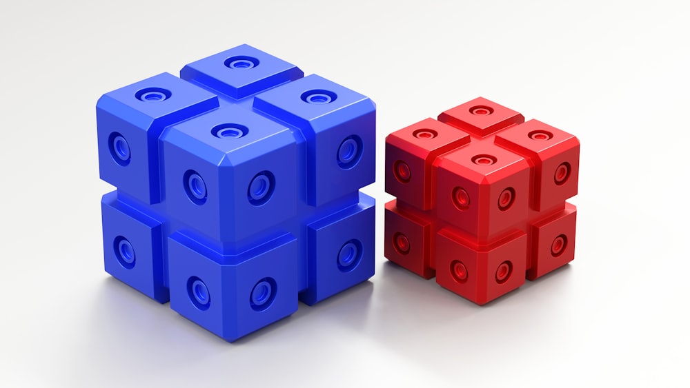 a red and a blue lego block sitting side by side