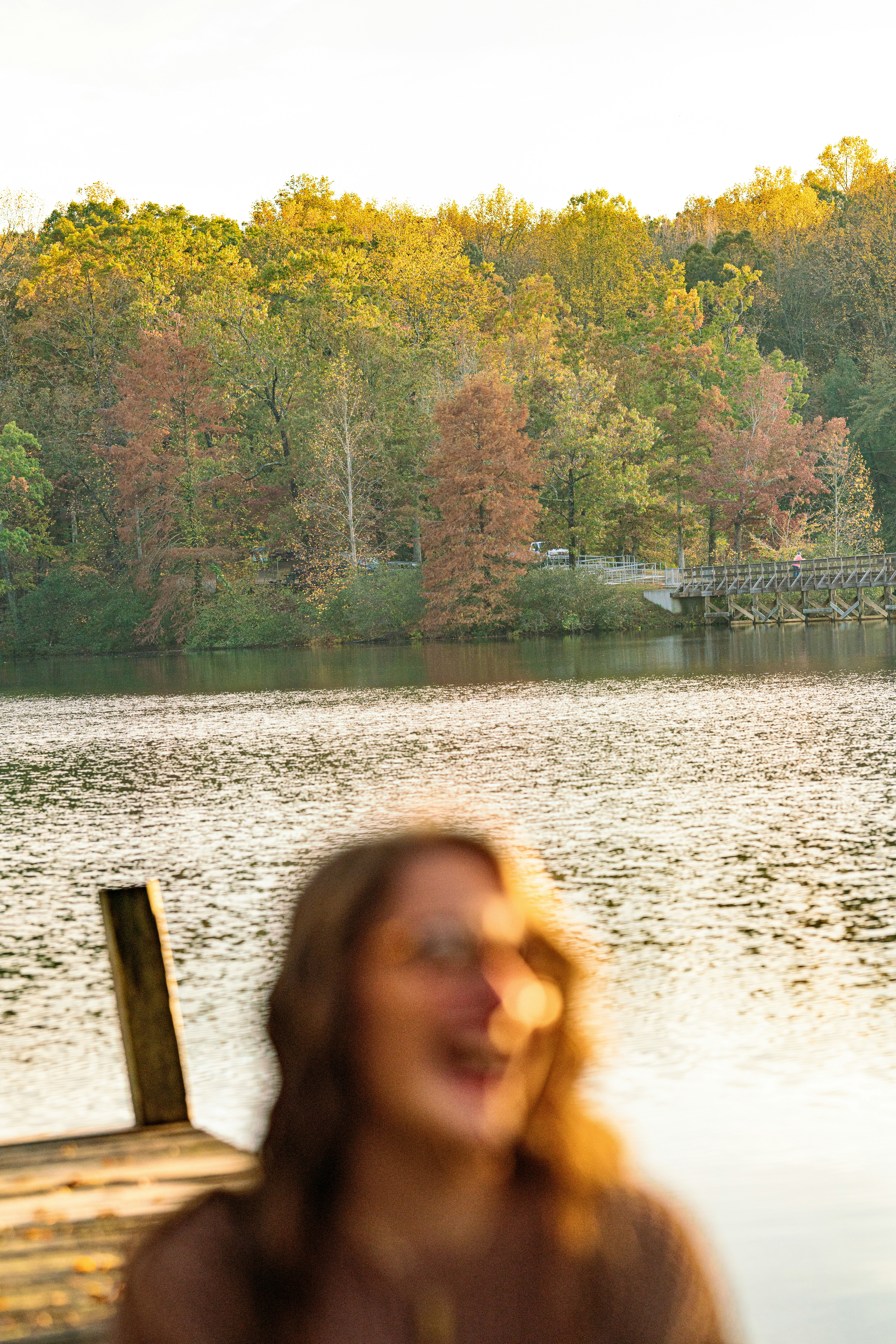 A woman standing next to a body of water photo – Free Woman Image on ...
