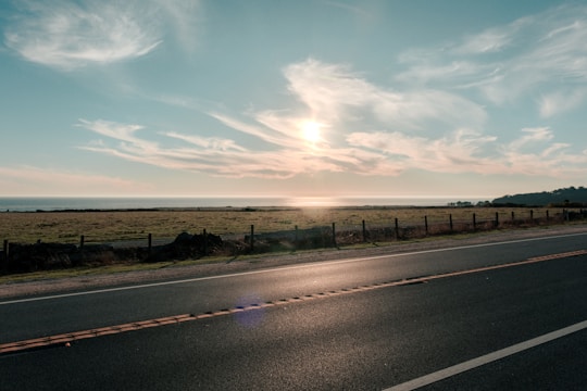 A serene landscape with a peaceful road leading to a horizon.