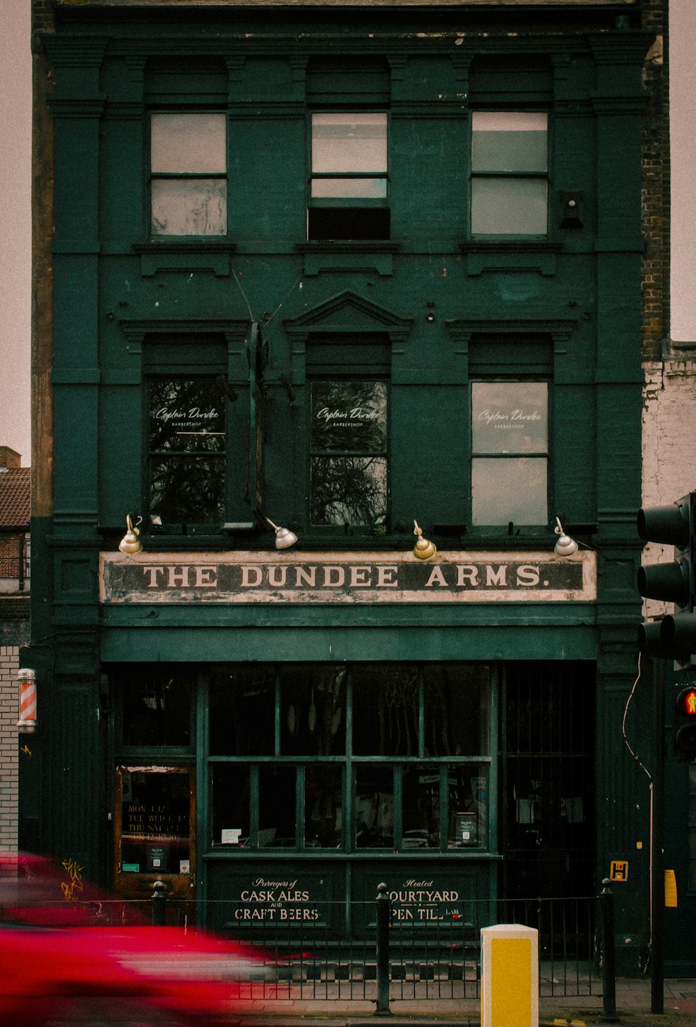 a green building with a sign that says the dunder arms