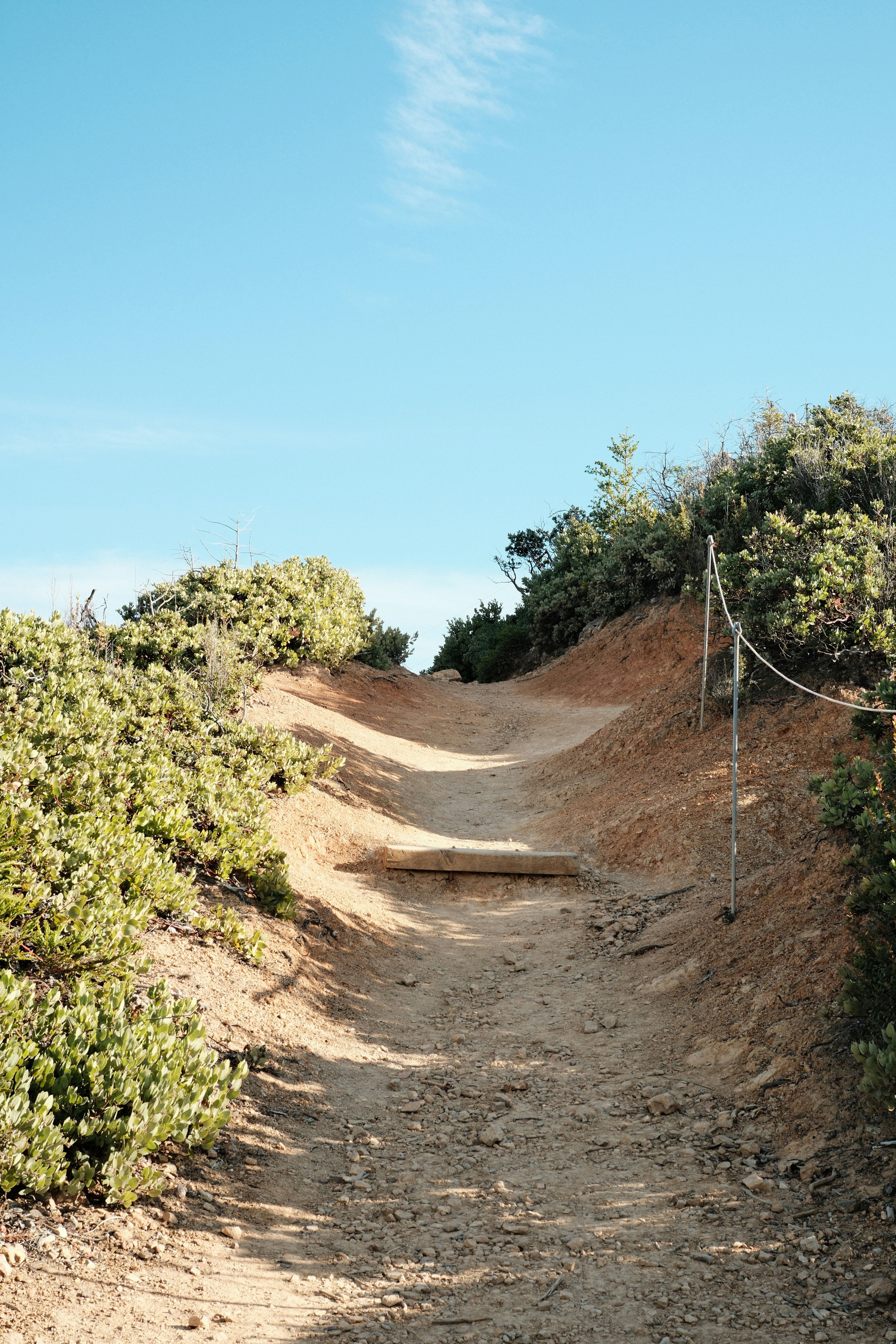 a dirt path with a volleyball net on top of it