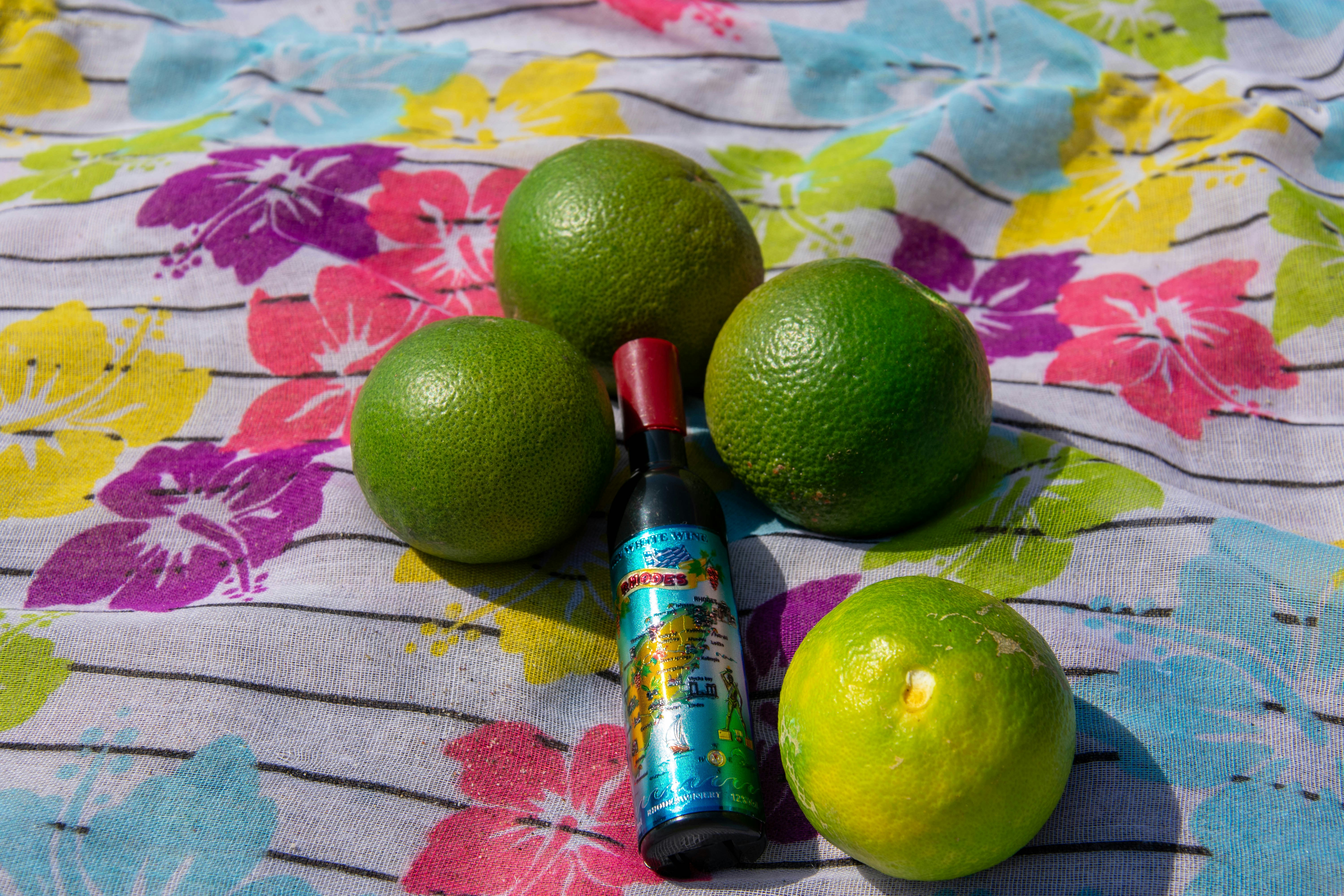 limes and a tube of deodorant sitting on a table