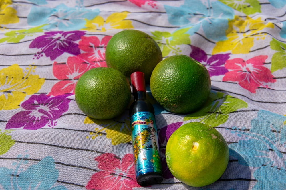 limes and a tube of deodorant sitting on a table