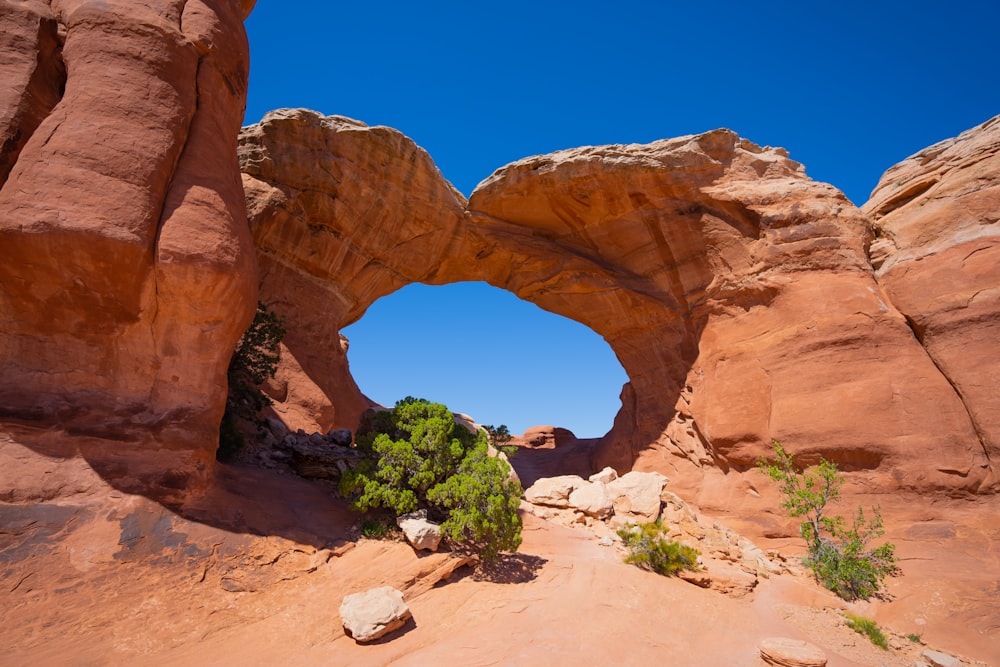 a rock arch in the middle of a desert