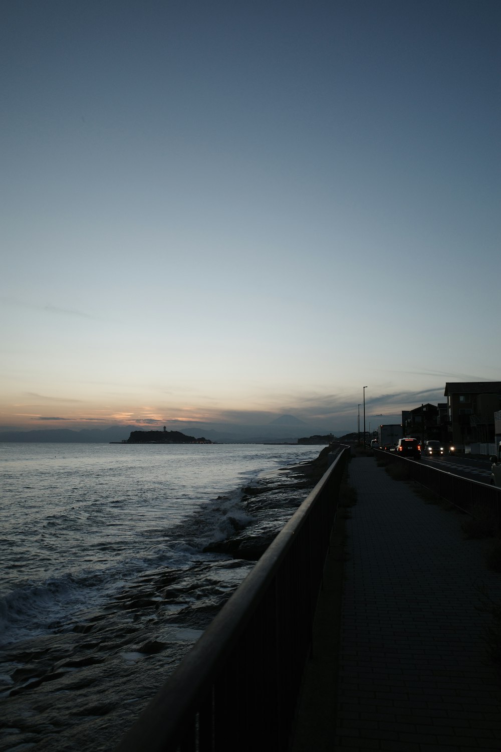 a view of the ocean from a pier at dusk
