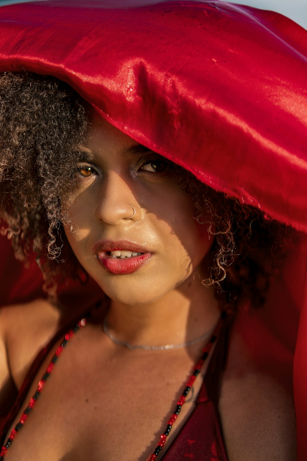 a woman in a red dress and a red hat