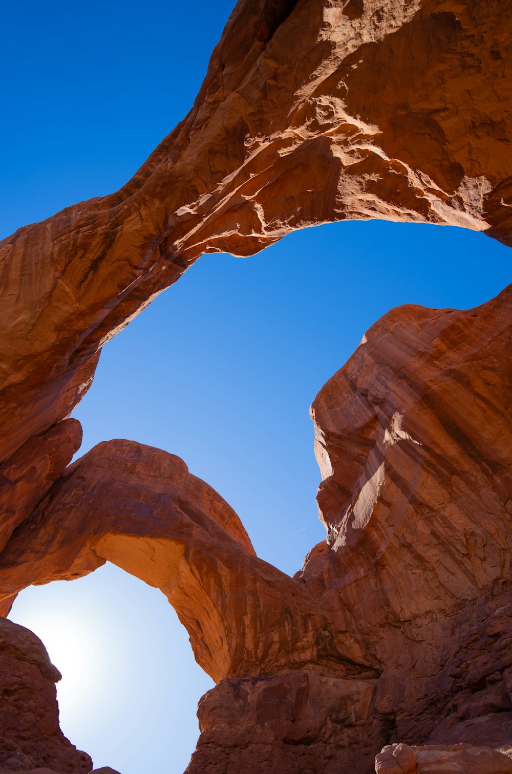 a large rock formation with a blue sky in the background