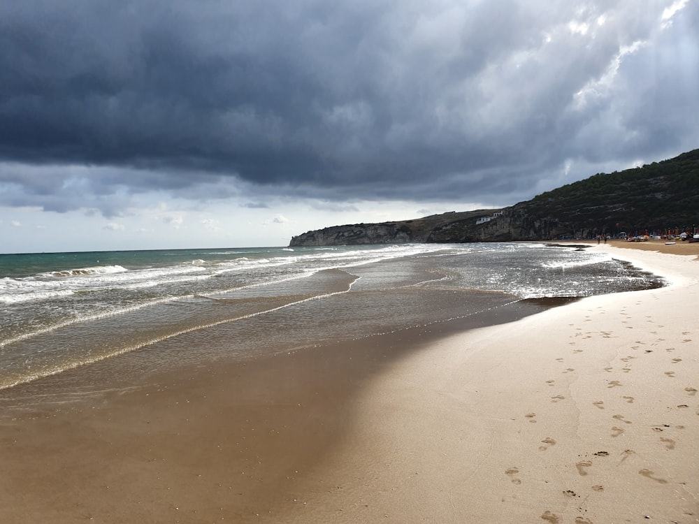 a sandy beach with footprints in the sand