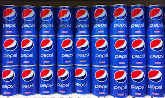 A vibrant display of chilled Pepsi bottles stacked neatly in a warehouse setting