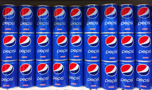 A vibrant display of chilled Pepsi bottles stacked neatly in a warehouse setting