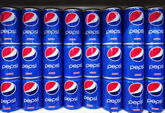 A vibrant display of chilled Pepsi bottles stacked neatly in a warehouse ready for distribution.