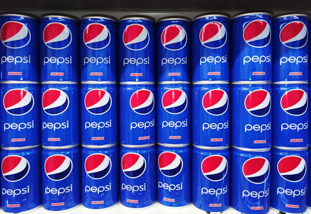 A vibrant display of chilled Pepsi bottles stacked neatly in a warehouse ready for distribution.