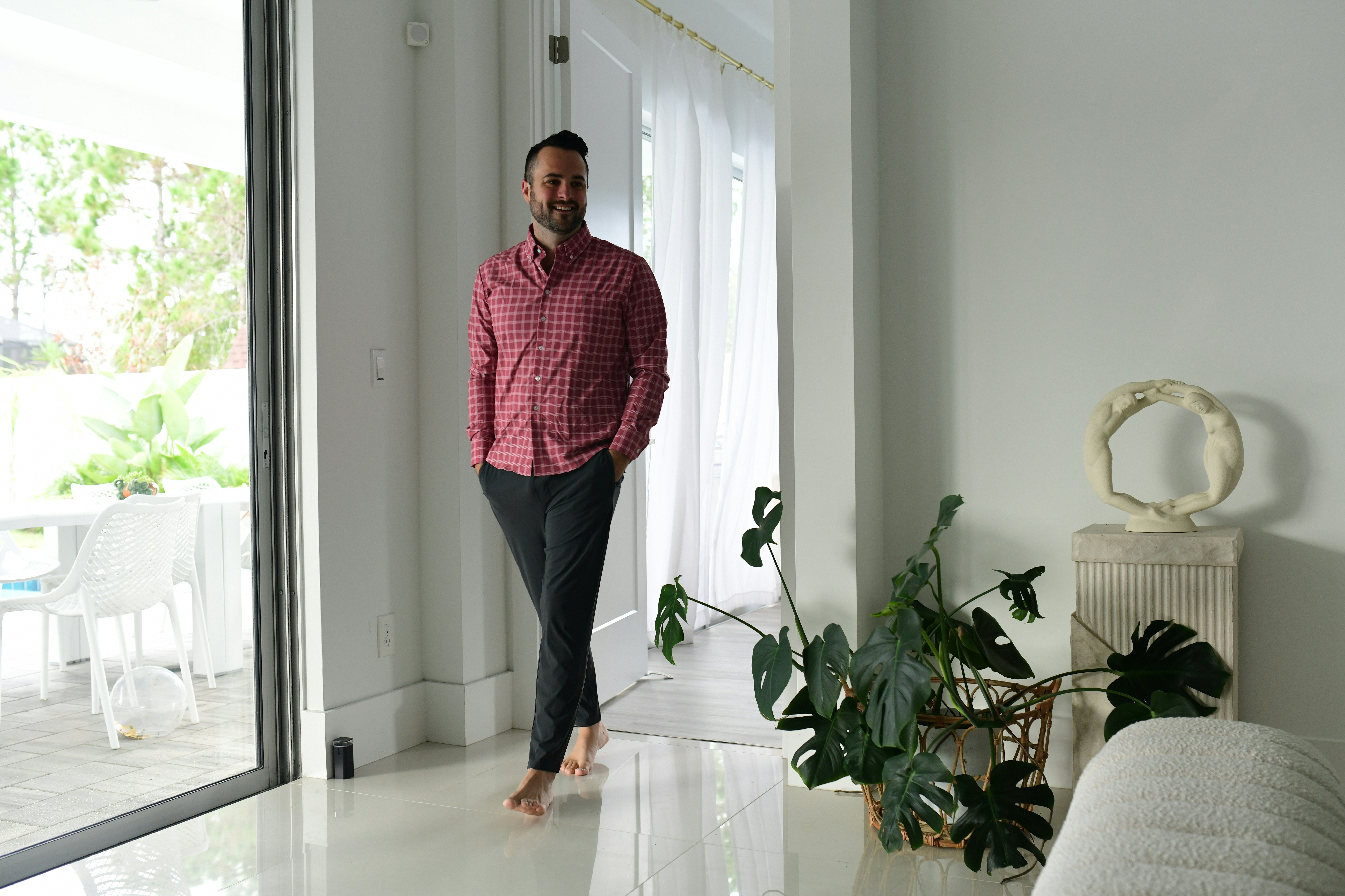 Rafael Domínguez, interior design lead at ArchStudio, standing in a beautifully lit residential interior with warm natural materials