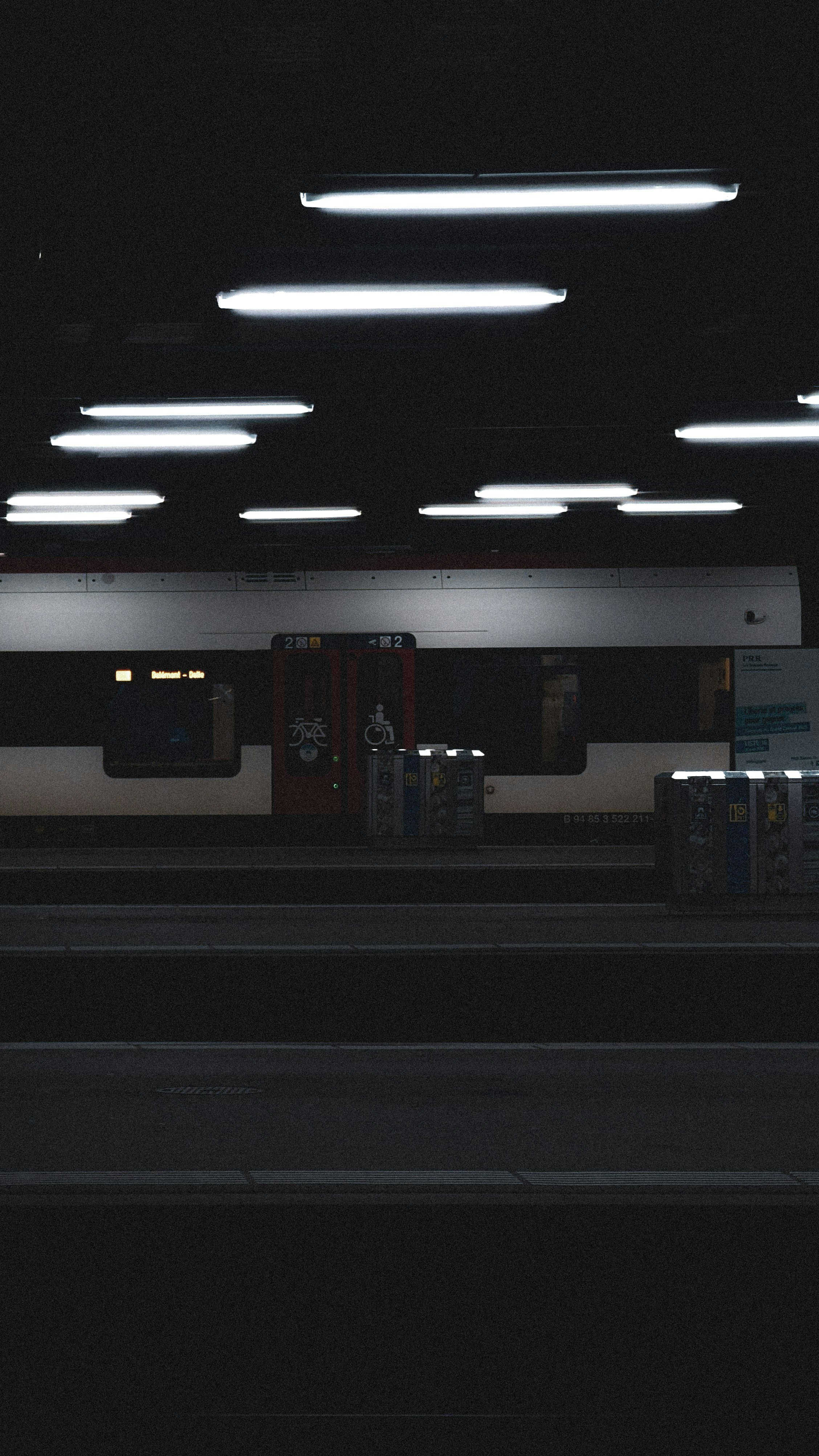 a train is parked at a train station at night