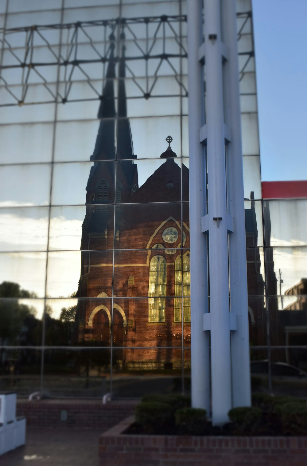 a reflection of a church in a glass building
