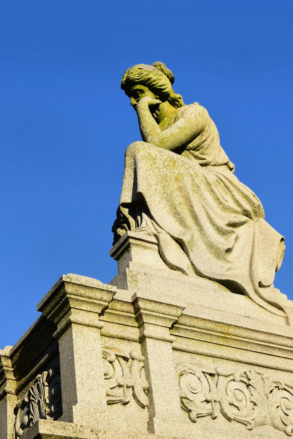 a statue of a woman with her hands behind her head