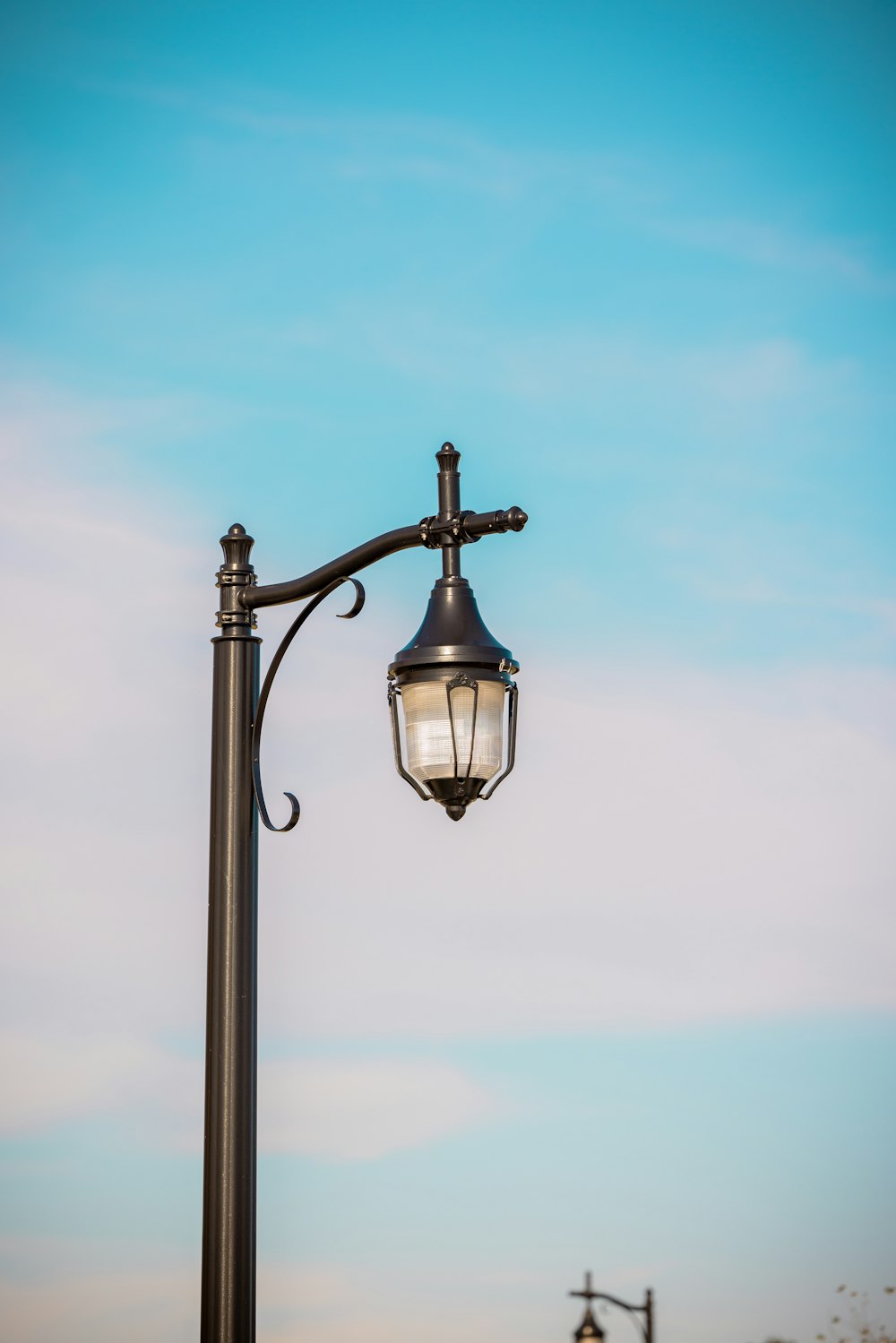 a lamp post with a street light attached to it