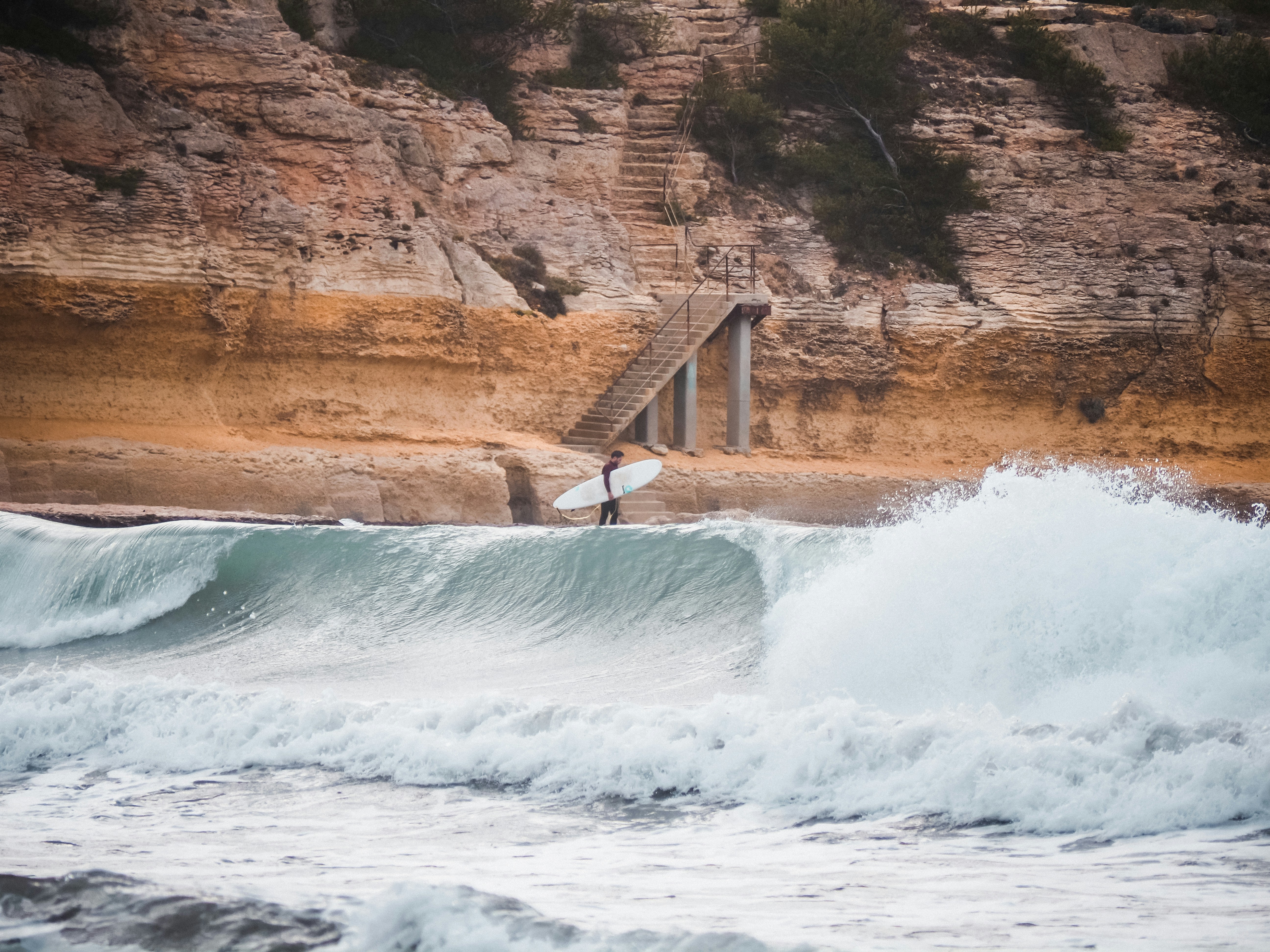 a person standing on a surfboard in the water