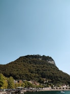 A scenic view of a Karadeniz village with mountains and sea in the background.