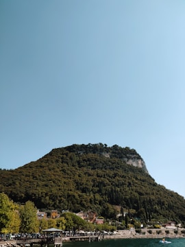 A scenic view of a Karadeniz village with mountains and sea in the background.