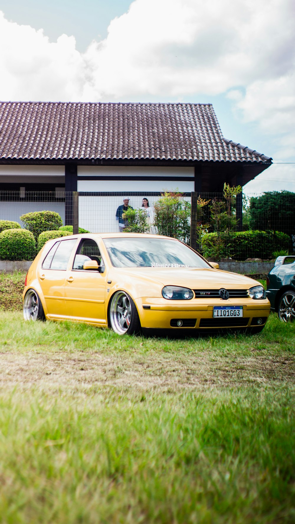 a yellow car parked in front of a house