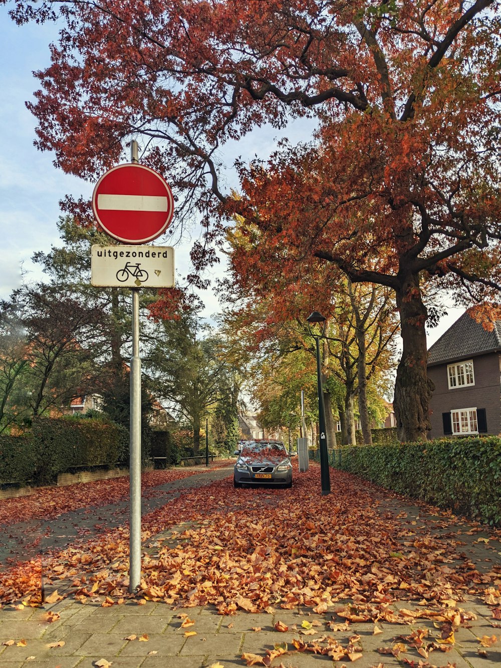 a red and white street sign sitting on the side of a road