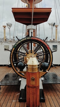 a golden fire hydrant sitting on top of a wooden deck