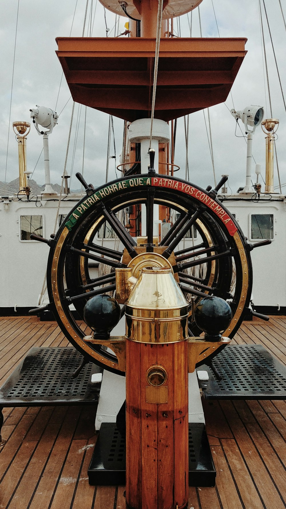 a golden fire hydrant sitting on top of a wooden deck