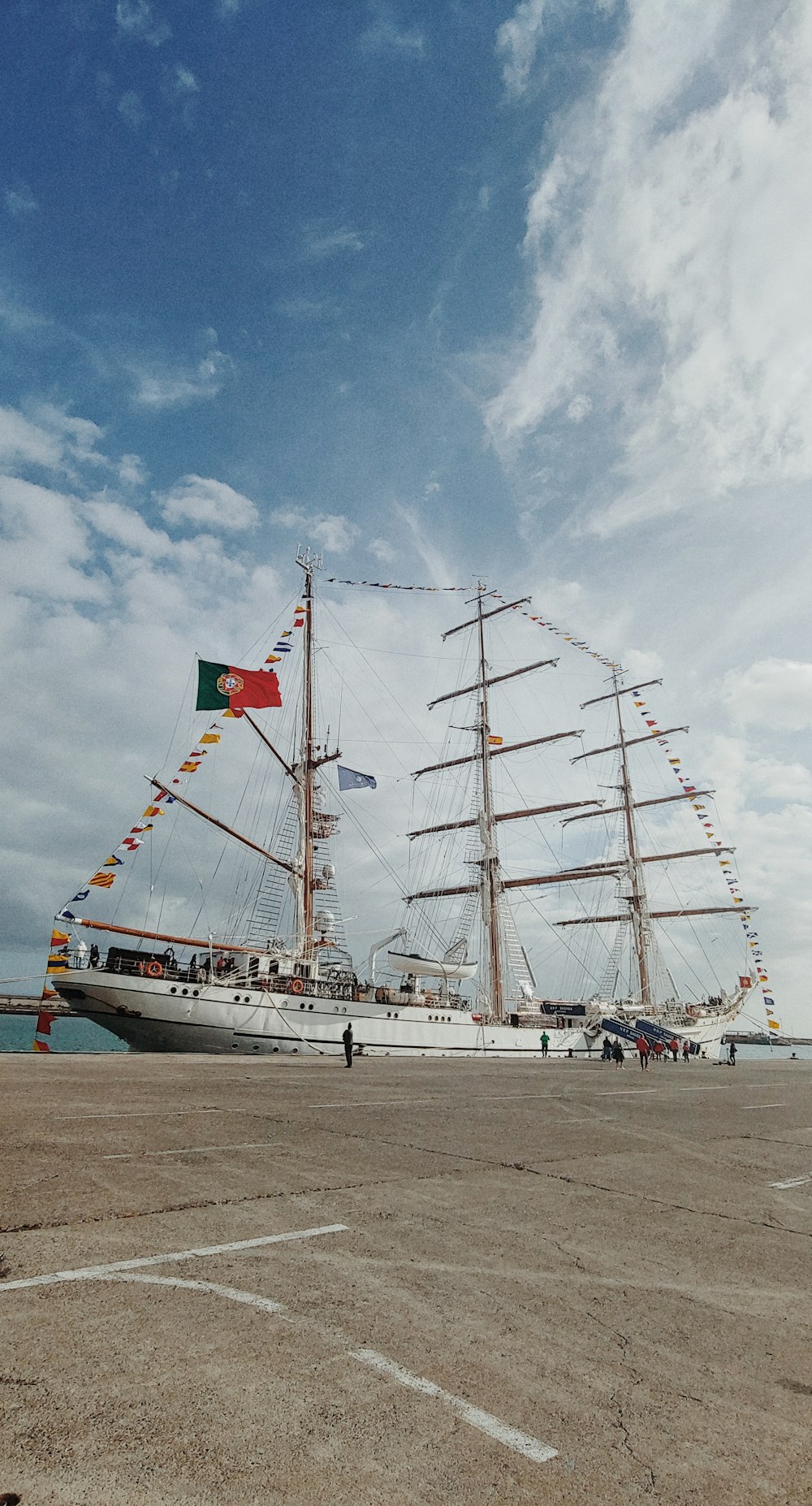 a large white boat with a flag on it's mast