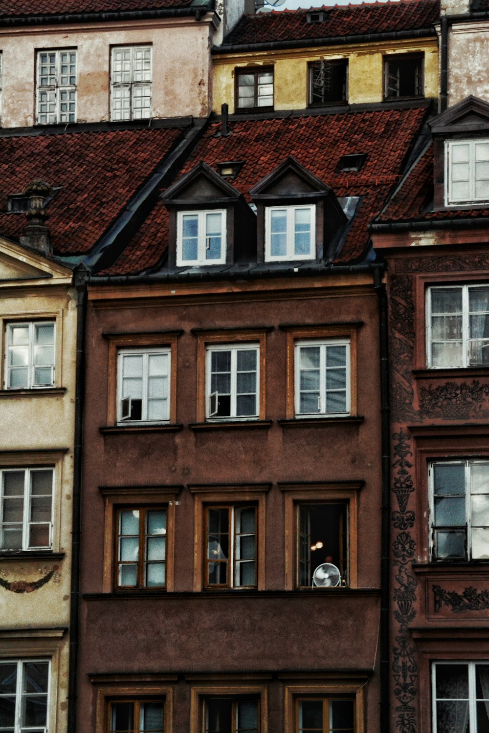 a group of buildings with a clock on the top of one of them