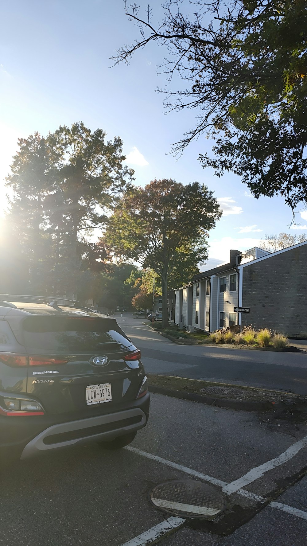 a car parked in a parking lot next to a building