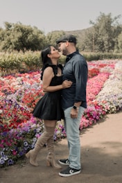 A romantic photo of David and Viktoriya holding hands in a sunlit garden.