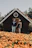 A smiling couple standing proudly in front of their new Atlanta home on a sunny day.