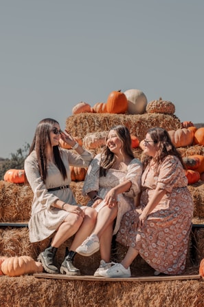 Smiling farmers gathered around a table sharing stories during harvest season.