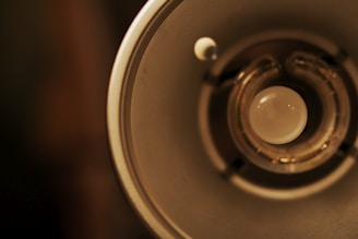 A close-up of hands examining a modern light bulb among other electrical items.