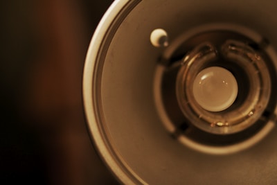 A close-up of hands examining a modern light bulb among other electrical items.