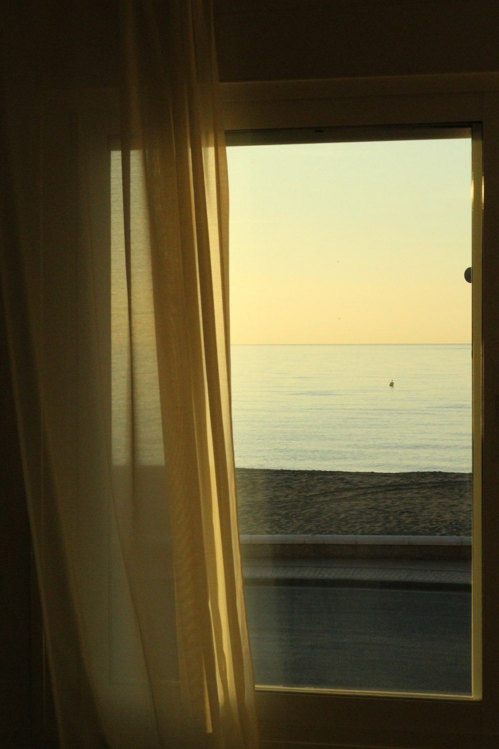 a window with a view of the ocean