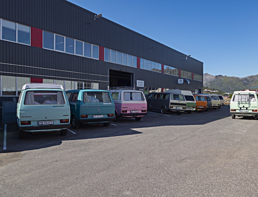 a row of vans parked in front of a building